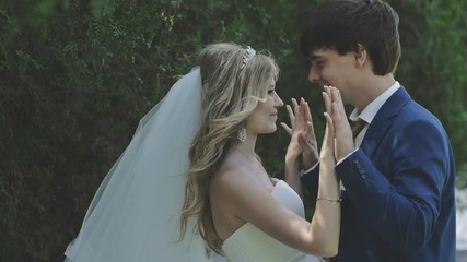 the bride and groom are on the background of trees. Newlyweds fooling around and laughing
