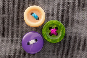 buttons on gray fabric in macro