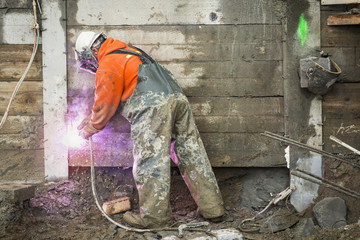 Construction worker welding at construction site