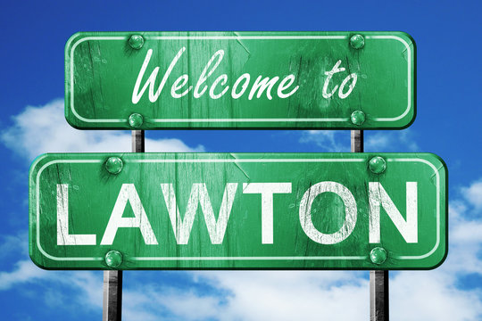 lawton vintage green road sign with blue sky background