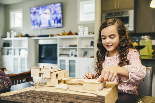 Mixed Race Girl Building Model House