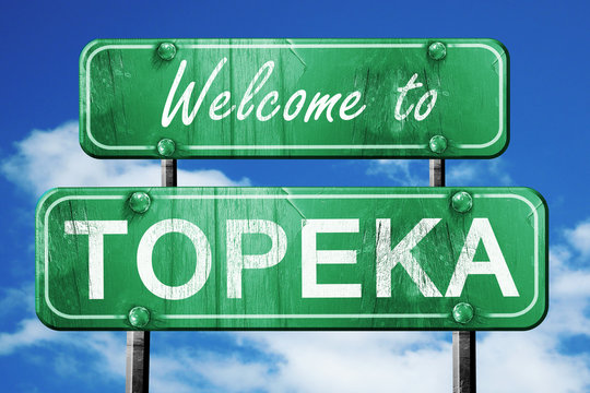 topeka vintage green road sign with blue sky background