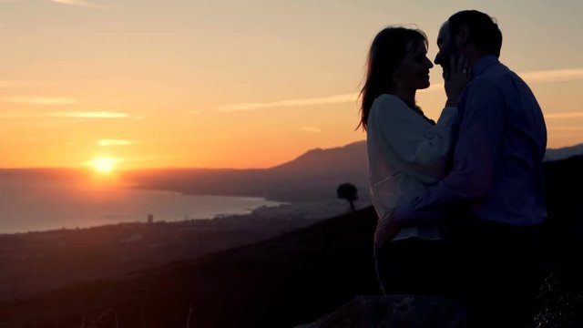 Couple in love kissing during sunset near sea
