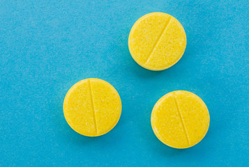 yellow tablets pills on a blue background