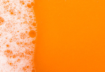 foam on orange background macro - obrazy, fototapety, plakaty