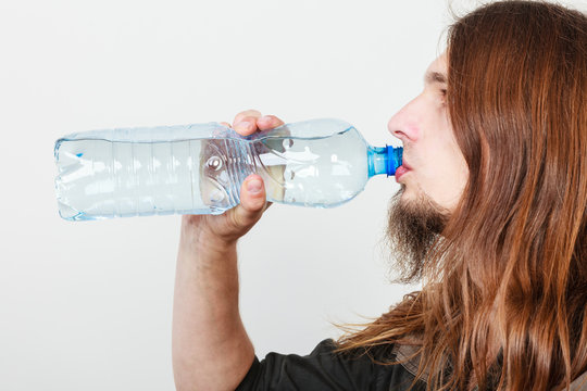 Man with bottle drinking water