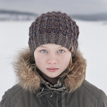 Portrait of teenage girl wearing knit hat in snow