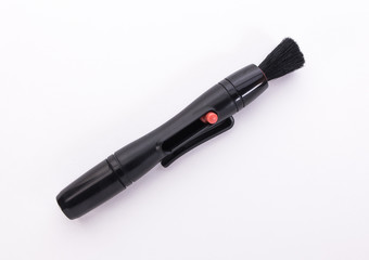 brush for cleaning the lenses on a white background