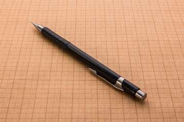 mechanical pencil on graph paper
