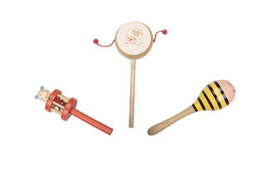 Wooden rattles and drum on a white studio background