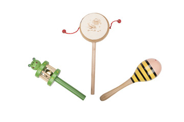 Wooden rattles and drum on a white studio background