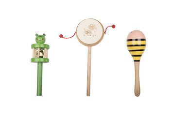 Wooden rattles and drum on a white studio background