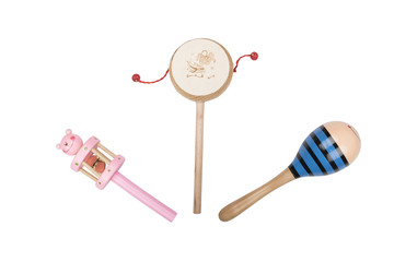 Wooden rattles and drum on a white studio background