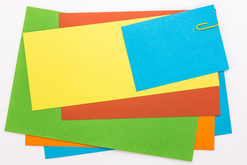 colored sheets of paper with a yellow clip