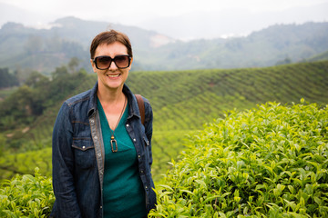 Smiling woman is on tea plantations of Cameron Highlands, Malays