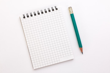 notebook and pencil on a white background