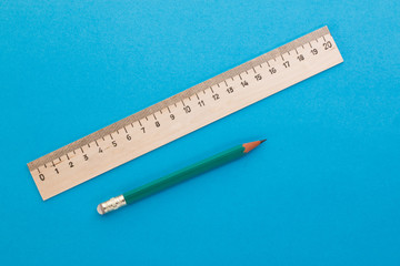 pencil and ruler on blue background