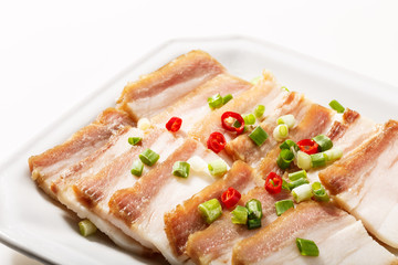 Cooked bacon On the white plate