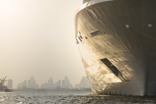 Bow Of Large Ship , Large ABangkok City In The Background At Eve