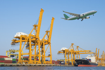 Fototapeta na wymiar Airplane and Container Cargo freight ship with working crane bri