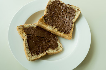 Bread with chocolate cream isolated on white background