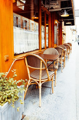 Street view of a coffee terrace with tables and chairs in europe