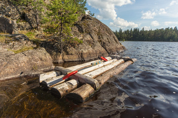 wooden raft at the rocky shore