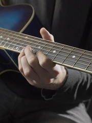 Fototapeta na wymiar man playing guitar close up