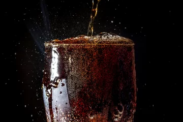 Foto op Plexiglas Soda large glass, overflowing glass of soda closeup with bubbles isolated on black background   © HappyRichStudio