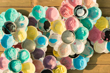 Art palette with paint color on dry color texture (top view)