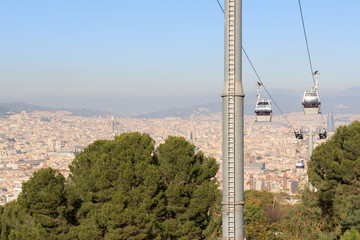 Fototapeta premium Aerial gondola lift with cable car and Barcelona cityscape panorama seen from Montjuic, Spain