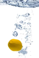 Poster  A background of bubbles forming in blue water after ice cubes and lemon are dropped into it. © lotus_studio