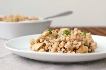 Oyster mushroom with barley grouts and spring onion on the plate