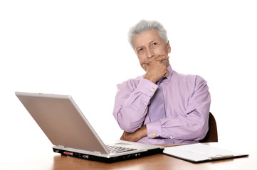Mature businessman working with laptop