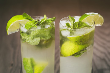 homemade mojito cocktail on wood table, vintage toned photo