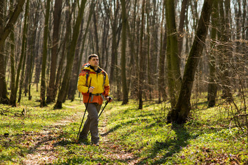 Fototapeta premium Active healthy man hiking in beautiful forest