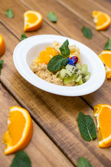 Tasty oatmeal with  apples on wooden table