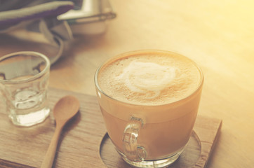 coffee cup on wood table and labtop