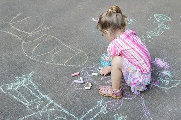 Naklejka premium Sidewalk chalk drawings of little Caucasian girl wearing pink ruffle skirt