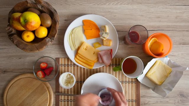 Continental breakfast with cheese, fruit and juice. Stop motion animation