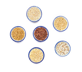 Variety of grain rice in cup on natural white background 