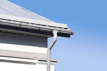 house corner with new rain gutter and downspout