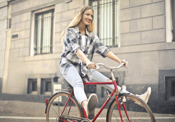 Fototapeta na wymiar Happy girl riding a red bike
