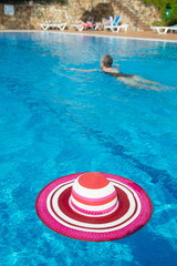 Pink sunhat at swimming pool