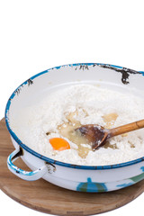 Raw egg in the flour with wooden scoop