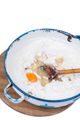 Raw egg in the flour with wooden scoop
