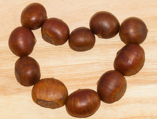 Heart shape chestnut on the wooden