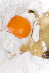 Raw egg in the flour macro shot