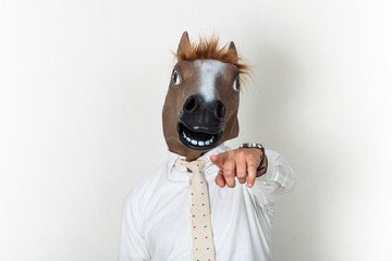 Businessman portrait wearing horse head wants you