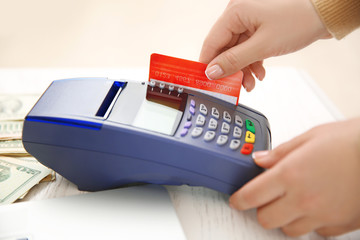 Female hand with credit card and bank terminal